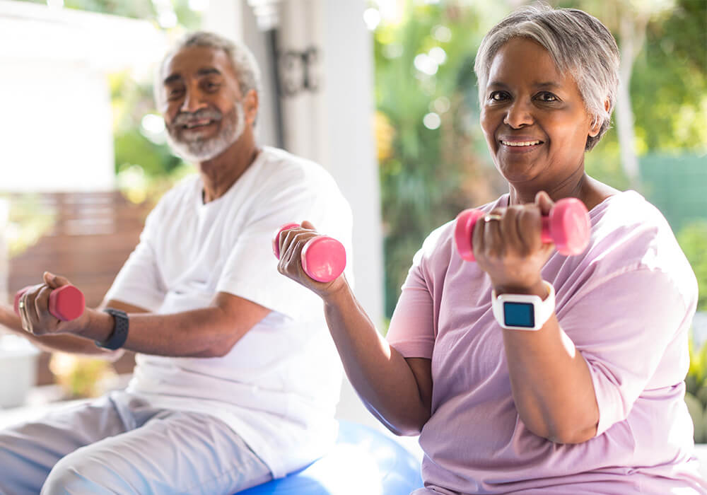 Senior couple exercises on yoga balls outdoors