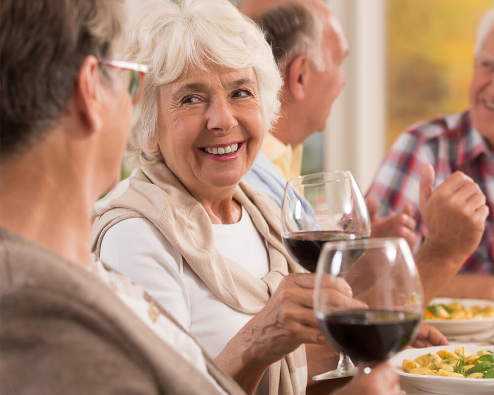 Senior friends enjoying dinner and drinks
