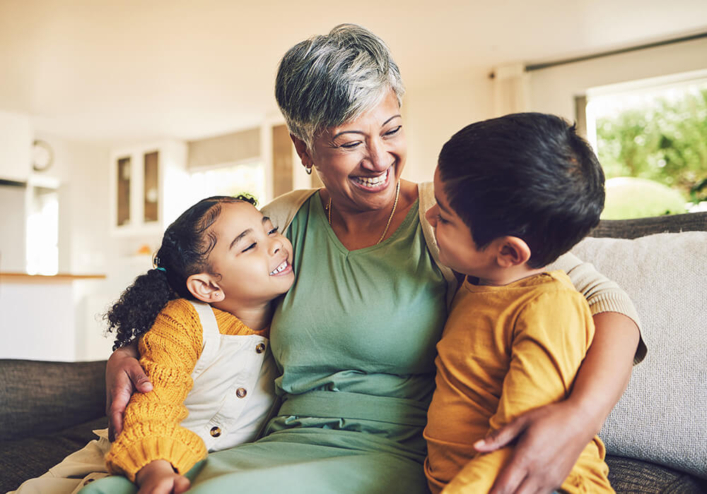 Senior woman holds two grandchildren